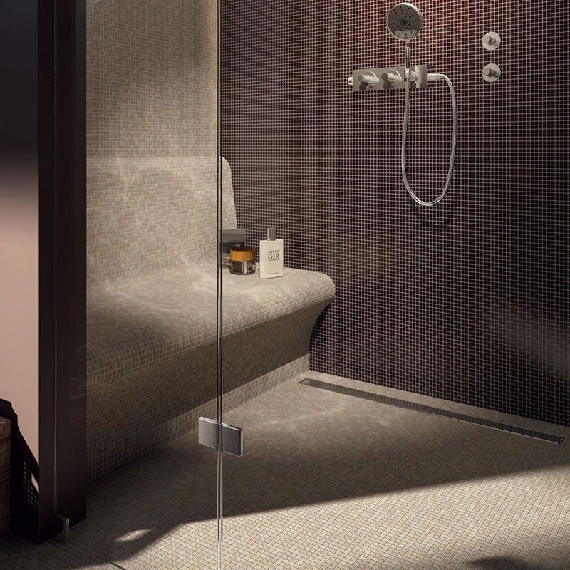 Modern steam room with a tileable bench seat and sleek shower fixtures.